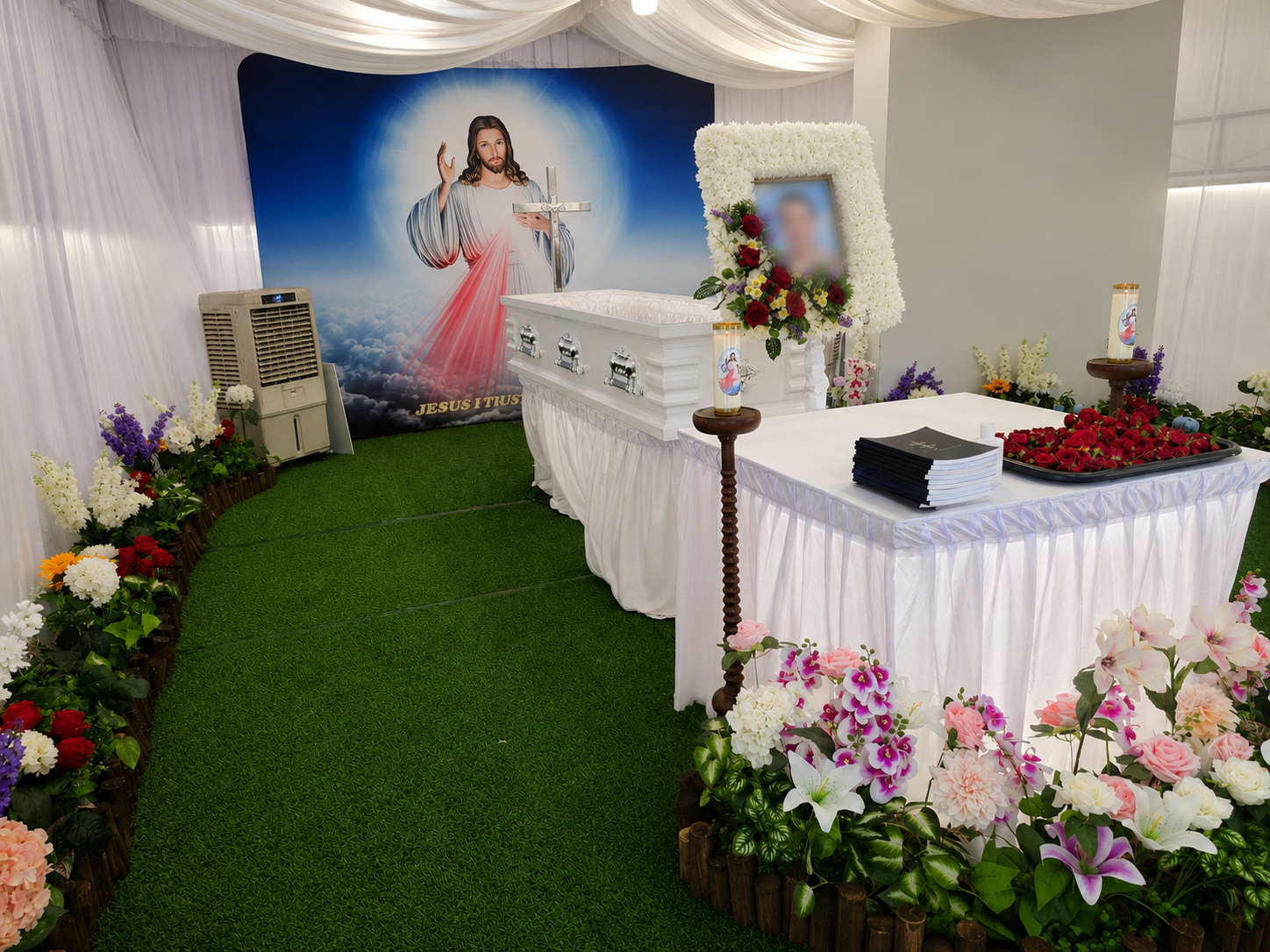 Christian funeral wake setup in Singapore with white casket, floral arrangements, candles and Jesus backdrop.